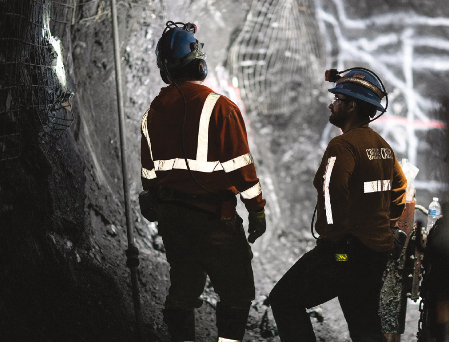 two men in mines wearing safety gear