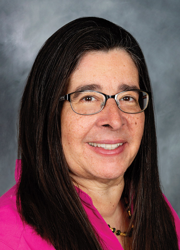 Portrait headshot photograph of Dr. Angelique Ramirez smiling