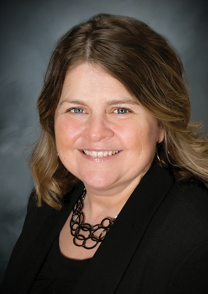 Portrait headshot photograph of Nicole Welch smiling
