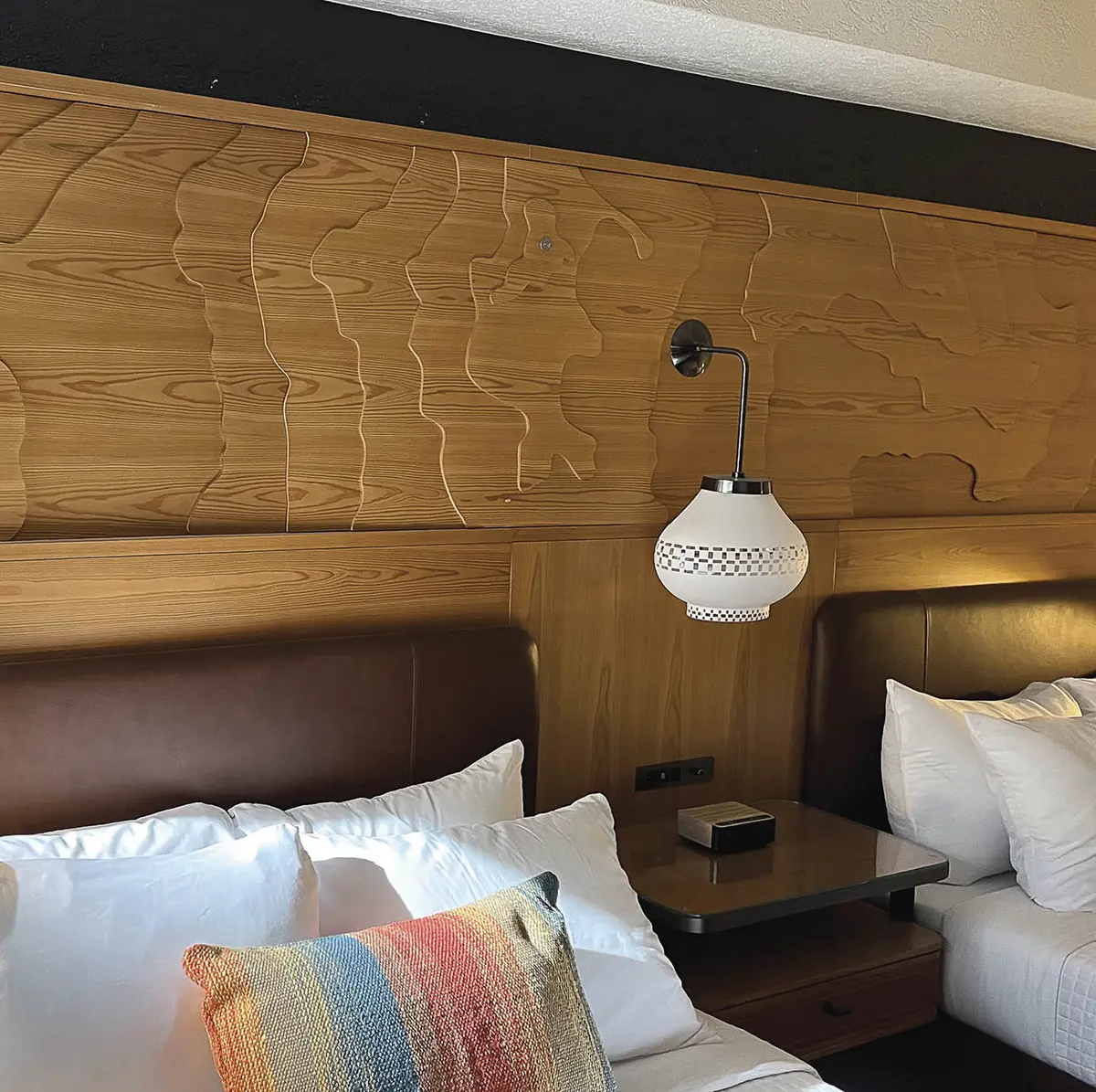 C-PACER, or commercial property assessed clean energy and resilience, is private financing facilitated by the city to pay for upgrades to the hotel’s wiring. To avoid ripping into walls, outlets are covered by decorative wooden panels.