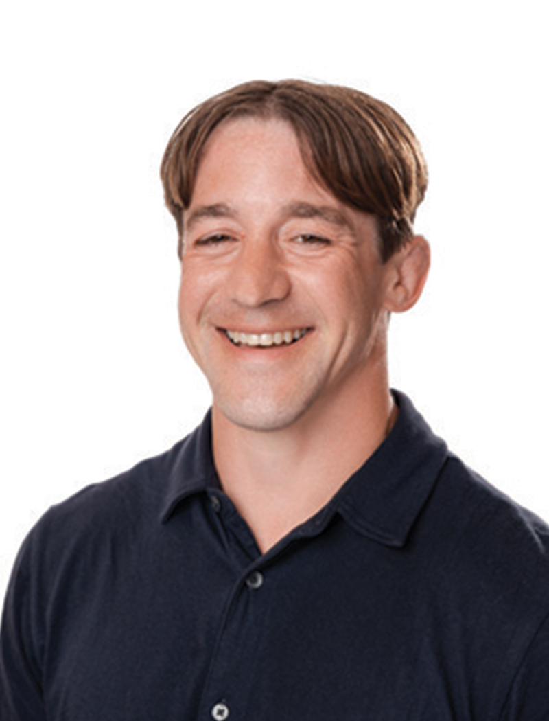 Headshot of a man wearing a black polo (Jared Mazurek)