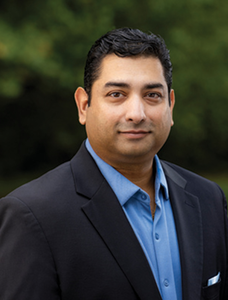 Headshot of a man wearing a suit jacket and blue shirt (Swami Iyer)