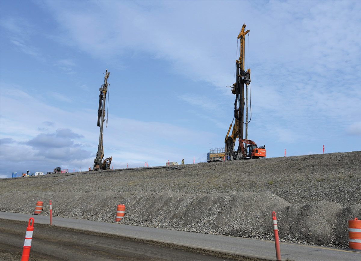 Aerial landscape photograph perspective of construction vehicles and other objects at the Moose Creek Dam area in North Pole, Alaska during the day