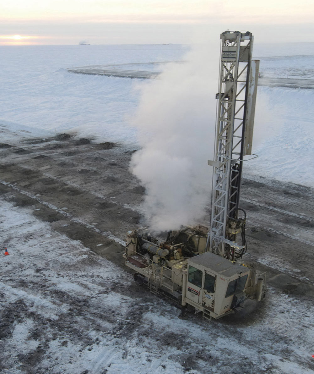 aerial view of a Cruz Construction crew drilling for a gravel shot in E pit at Prudhoe Bay 