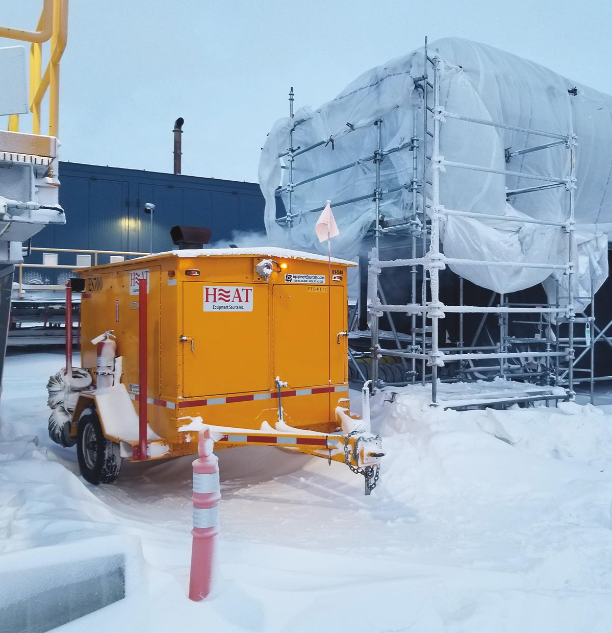 yellow portable heater sitting outside in the snow