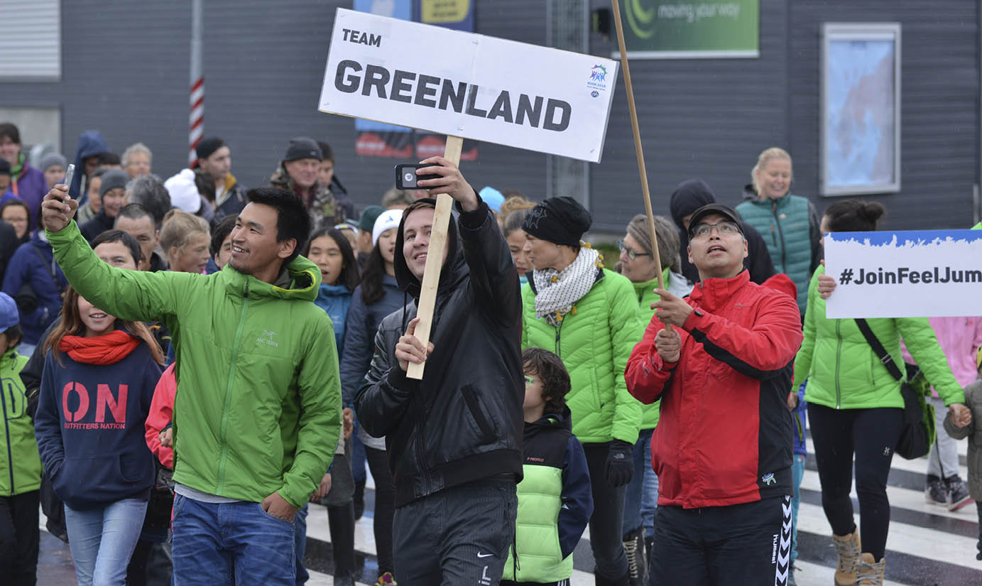 Team Greenland holding up their respective sign