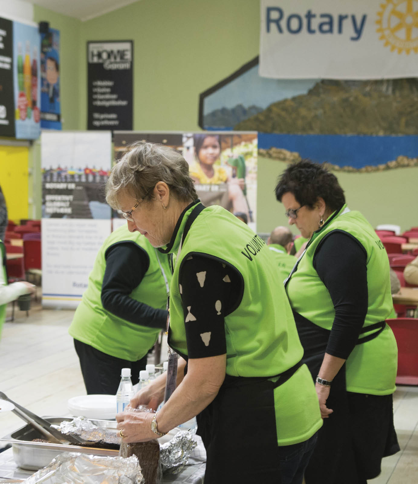 volunteers help pack food for the participants