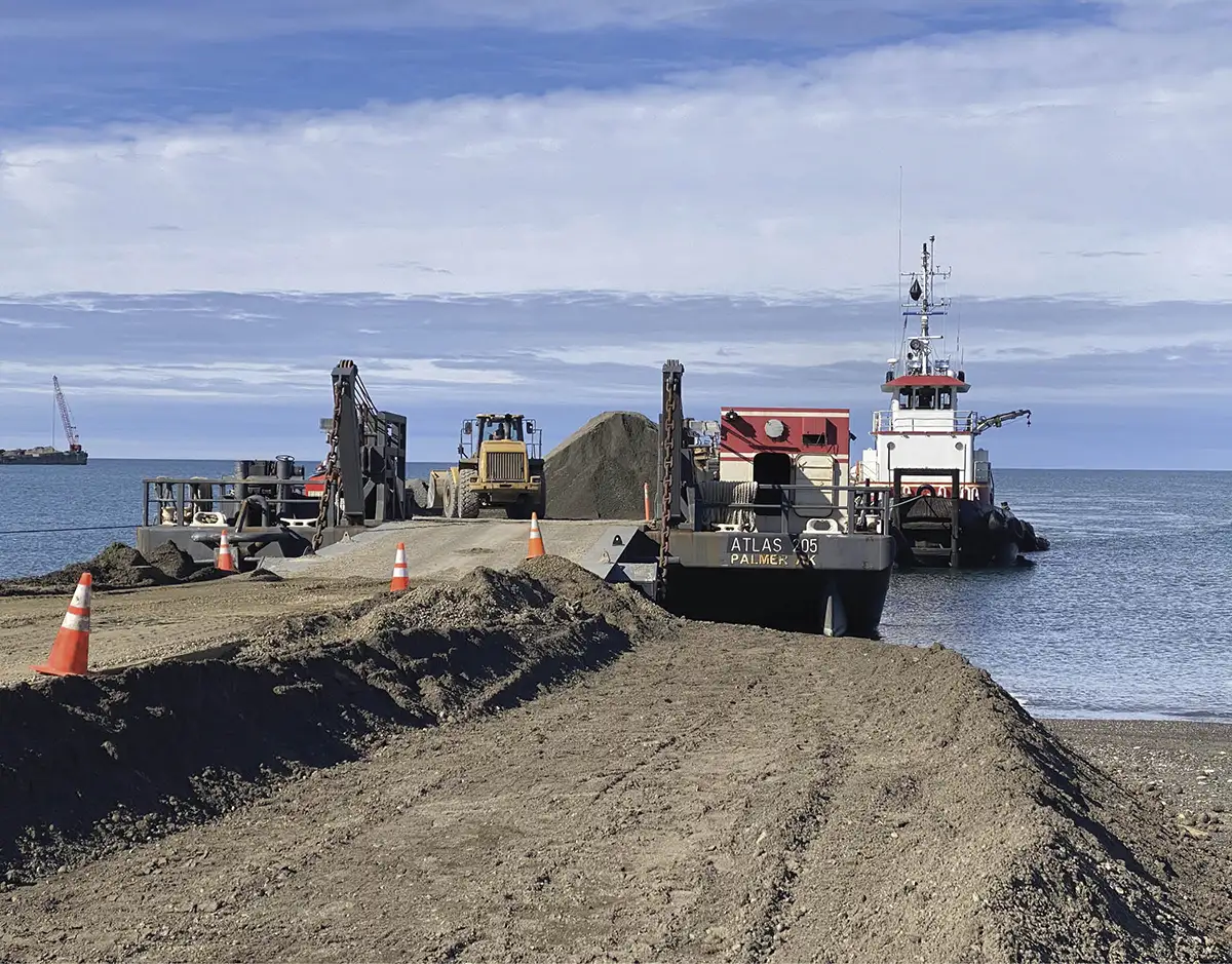 Cruz Construction employees offload gravel from the Atlas 205 barge in Utqiaġvik during the summer 2022 barging season