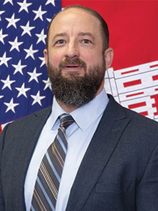 Headshot of a man wearing a suit and tie