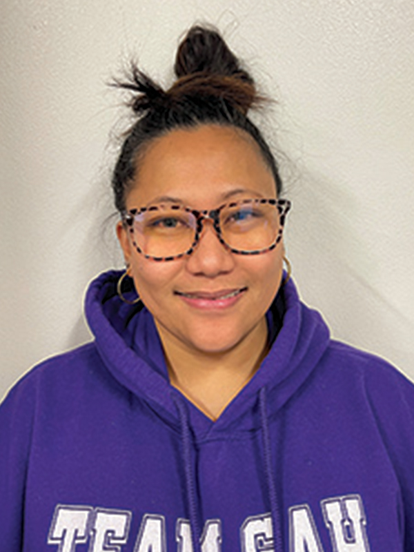 Headshot of a woman wearing glasses and a purple sweatshirt