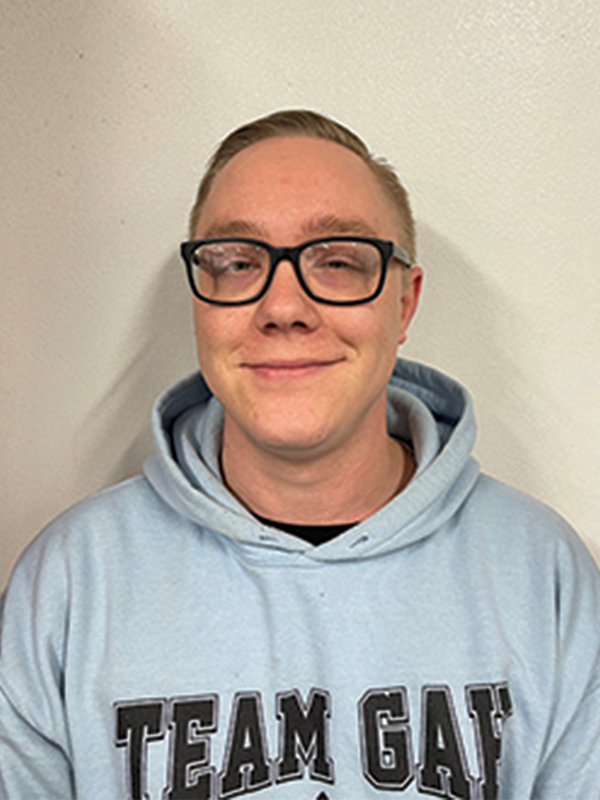 Headshot of a man wearing a gray sweatshirt