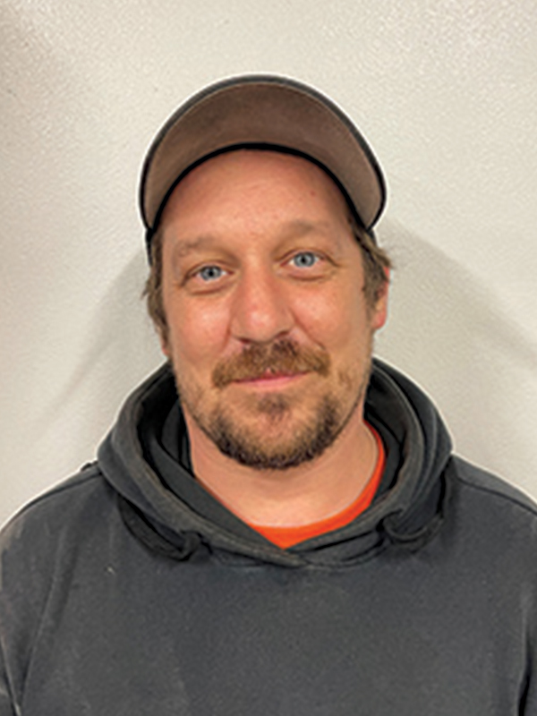 Headshot of a man wearing a gray sweatshirt and a ball cap