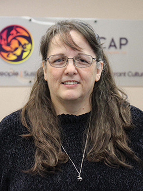 Headshot of a woman with long dark hair wearing a black shirt