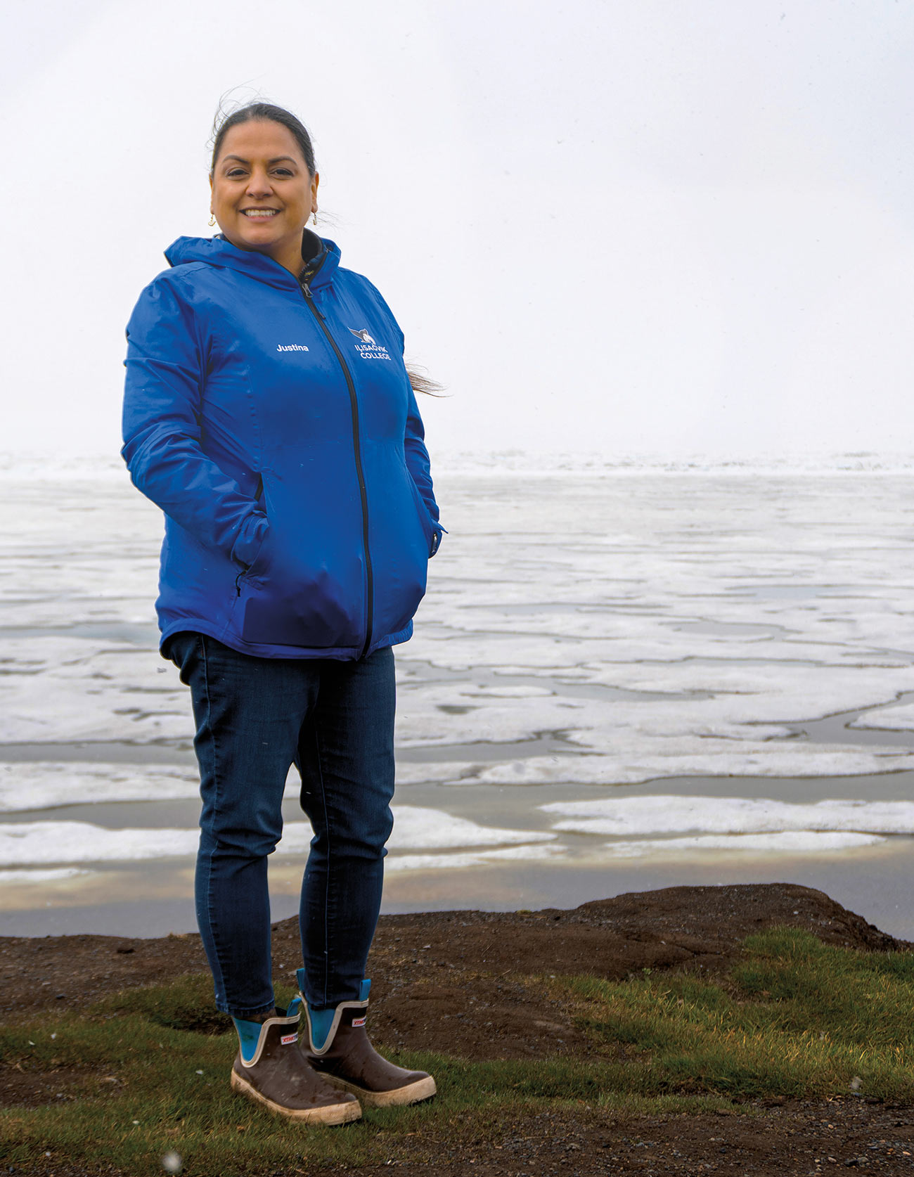 Justina Wilhelm standing near cliffside with icy sea in background