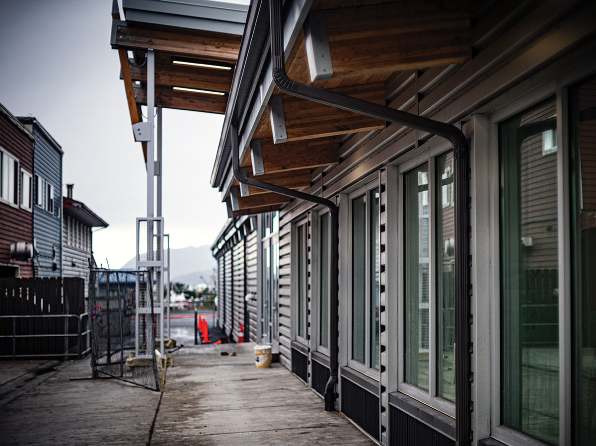 Close-up angle portrait photo outdoor view of a partially covered alley serving as a pedestrian connection between Kodiak's waterfront and the indoor shopping center