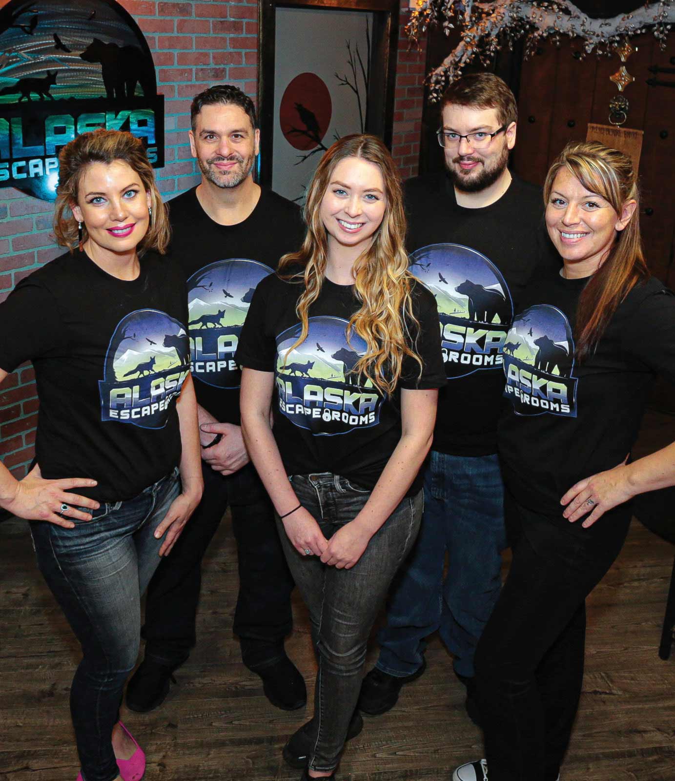 Alaska Escape Room employees smile inside one of the rooms