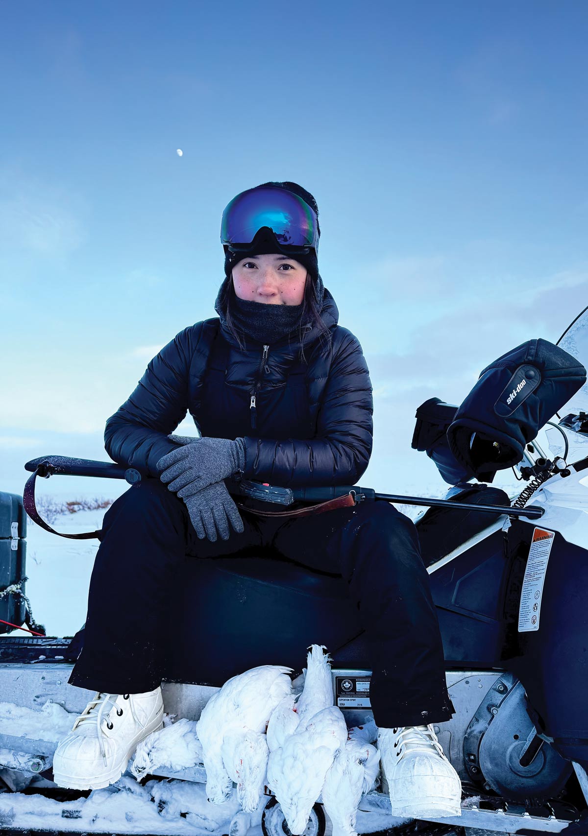 person wearing snow gear and white bunny boots