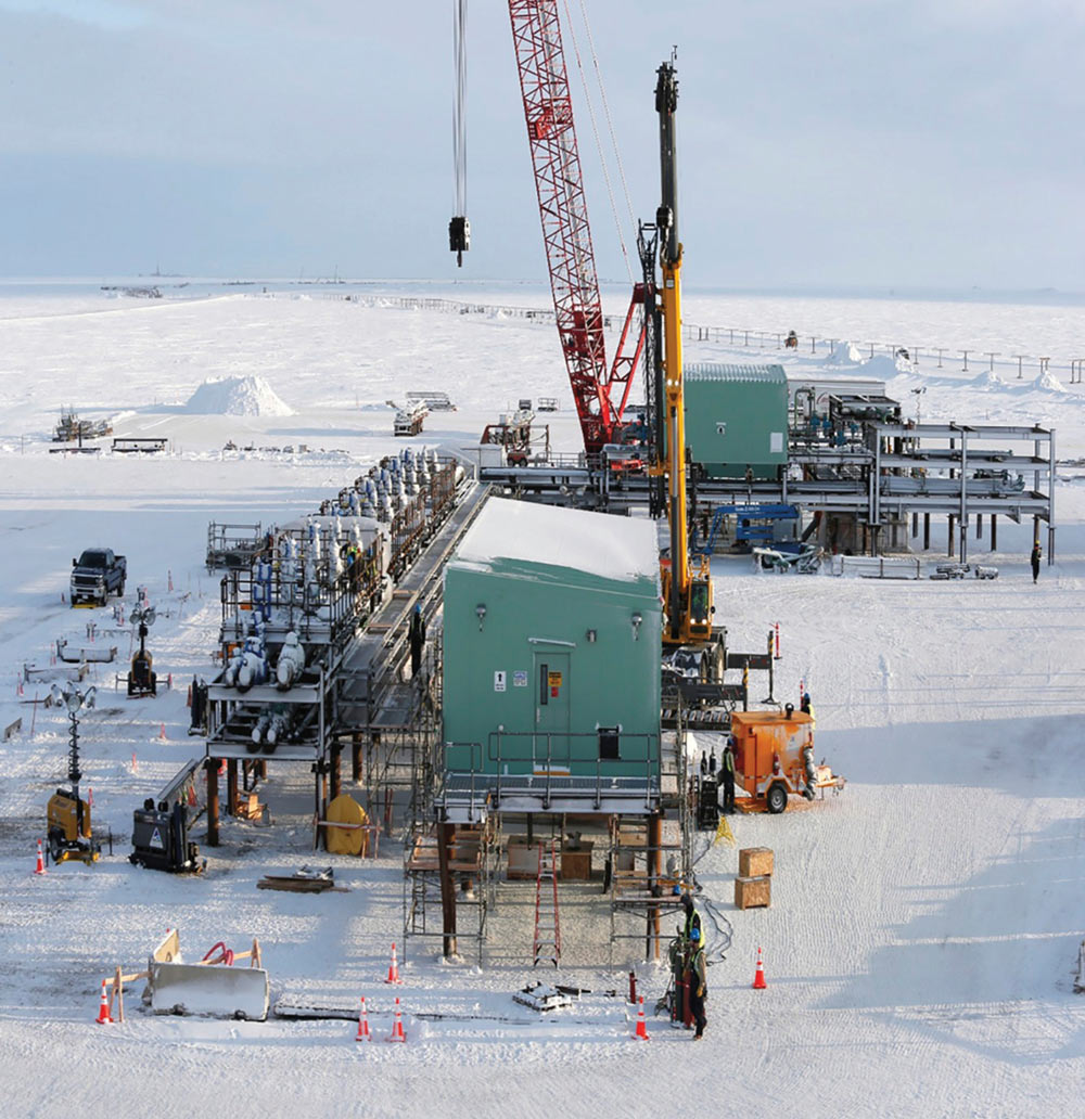 Snow-covered scene with a massive crane towering over the wintry terrain.