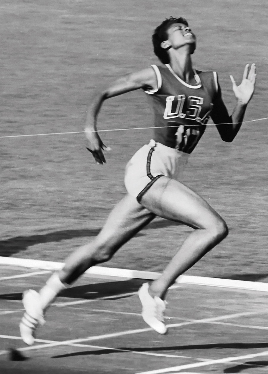 black and white photo of Wilma Rudolph running in a 100-meter dash