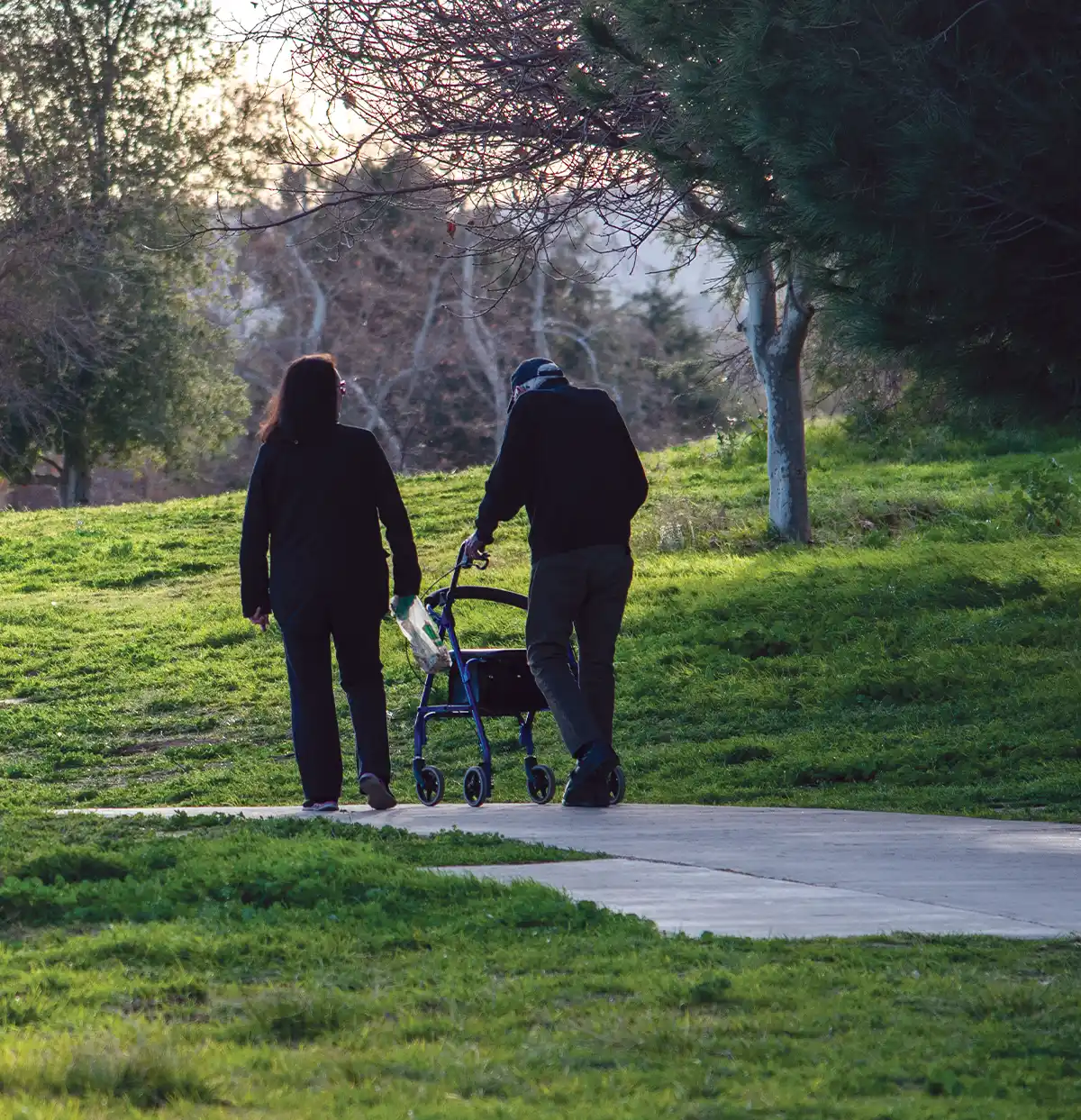 two people walking through a park