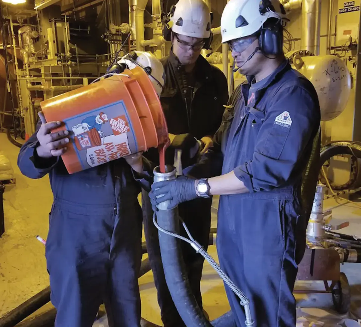 workers pouring epoxy into pipes