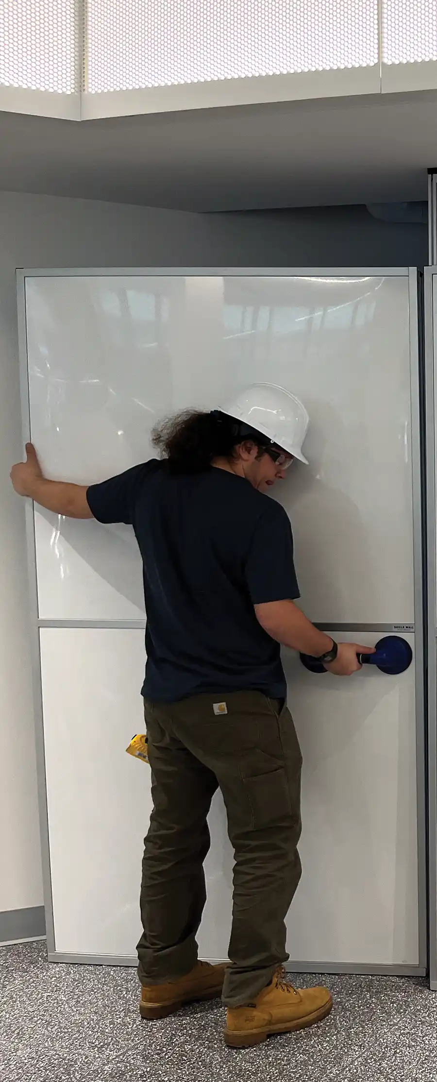 man installing a reusable wall