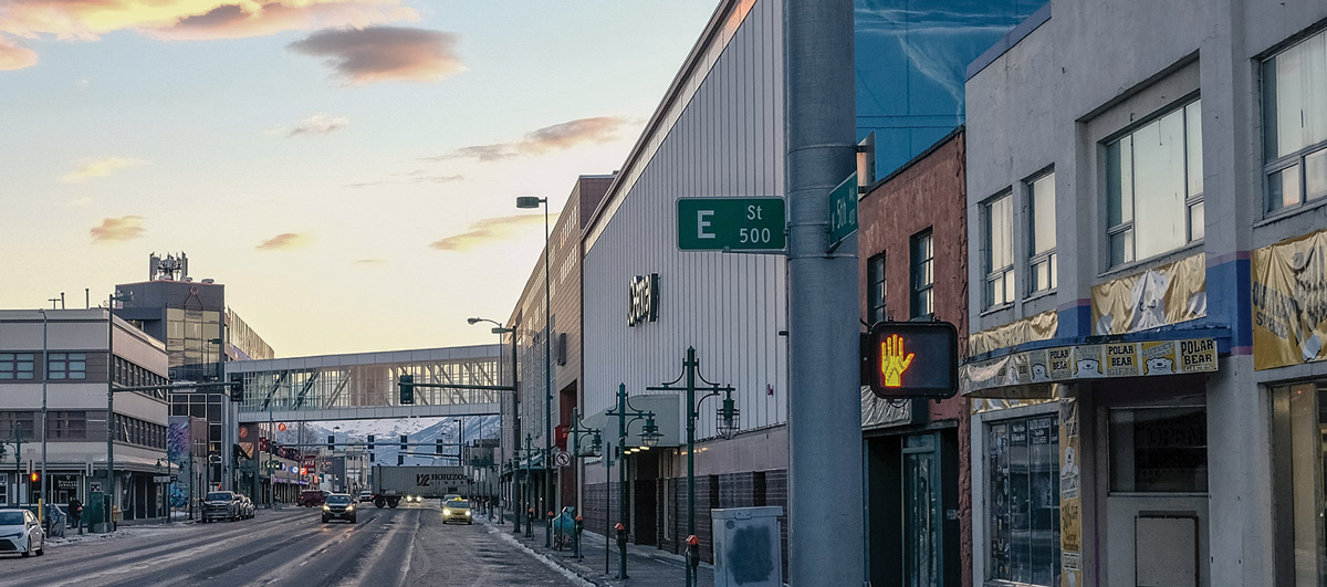 buildings along both sides of a street during sunset