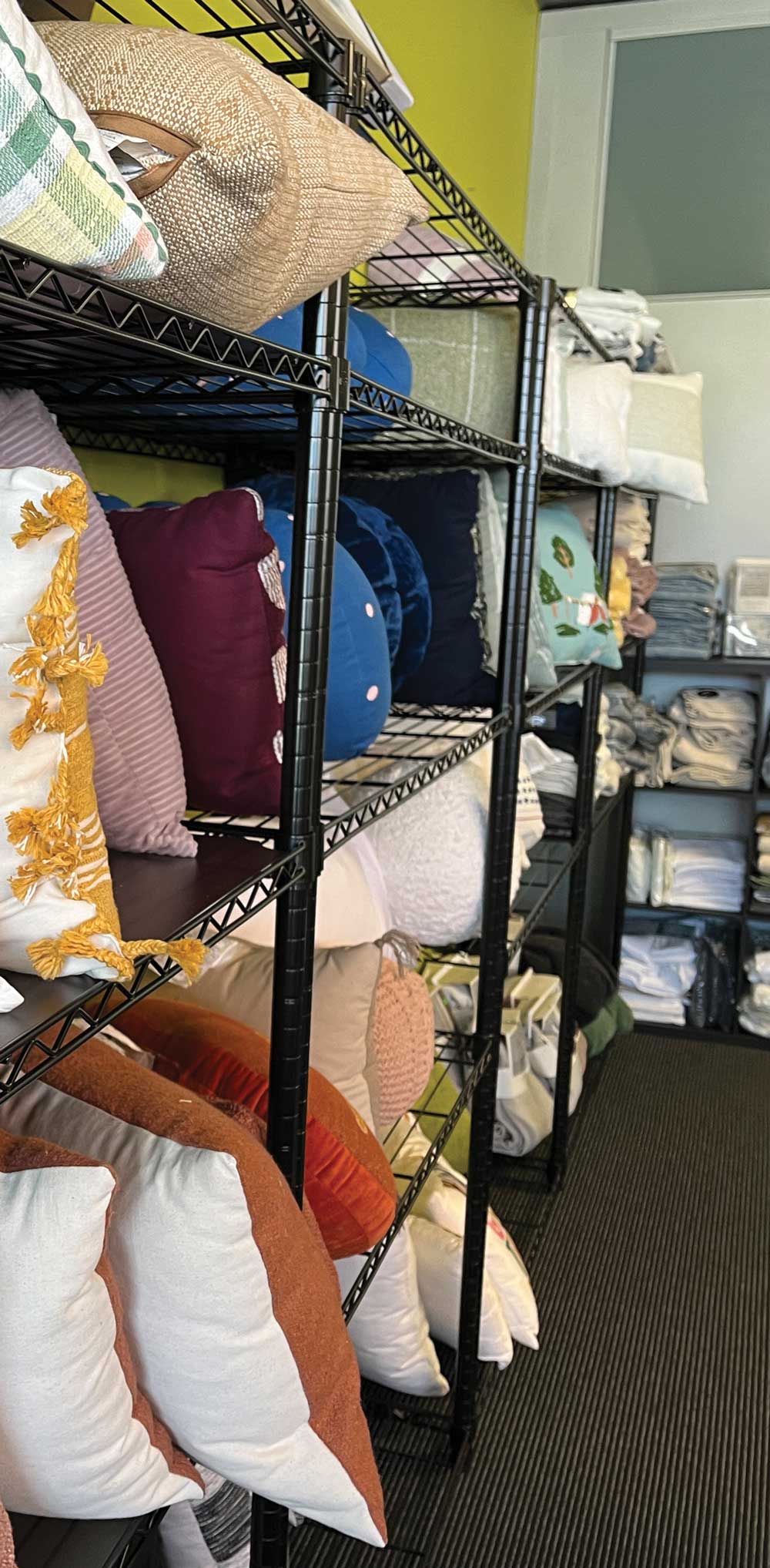 colorful pillows neatly arranged on shelves