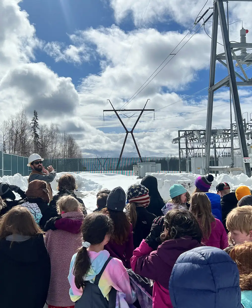 students on a field trip learn more about Matanuska Electric Association from a tour guide