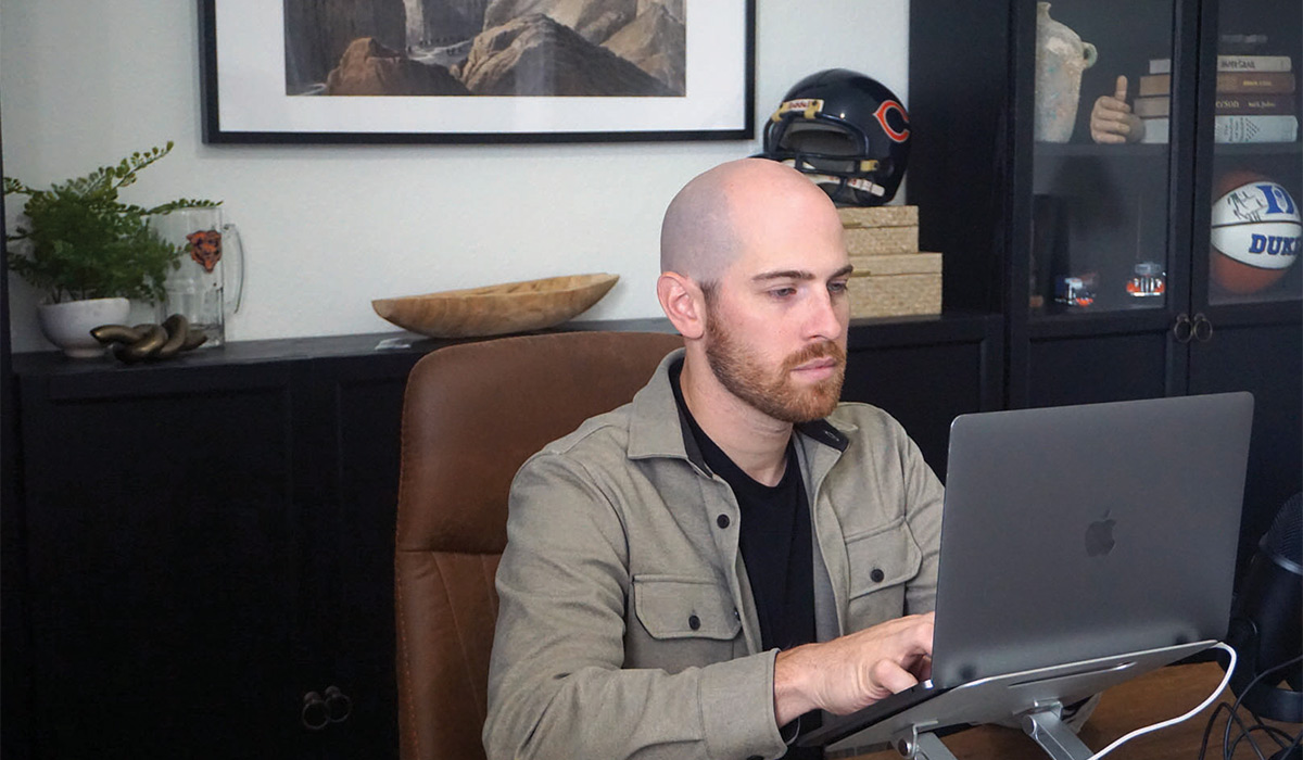 Mitchell Slater browsing on a laptop in his office