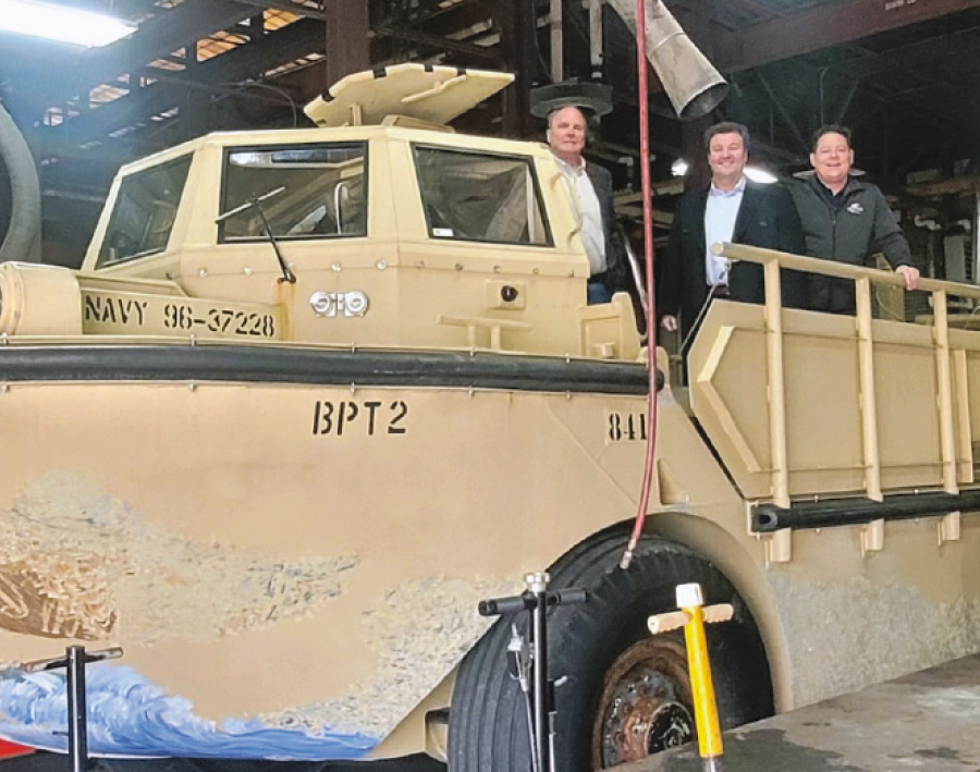 three men on US Navy vehicle