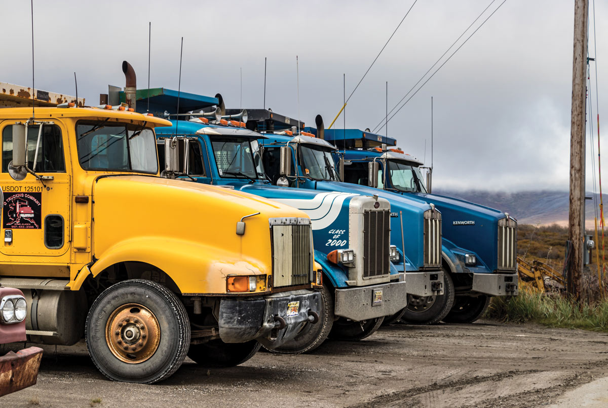 multiple semi-trucks lined up 