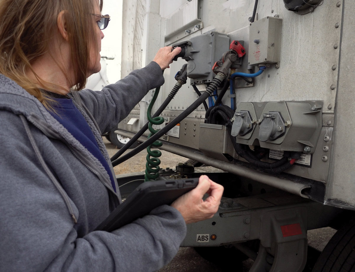 woman inspecting her truck 