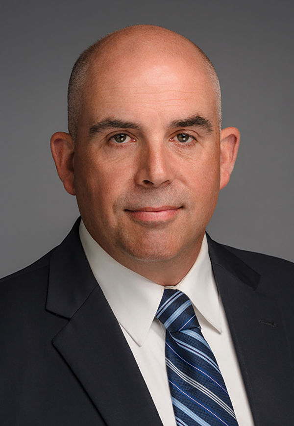 Portrait headshot photo of Bernard Chastain grinning