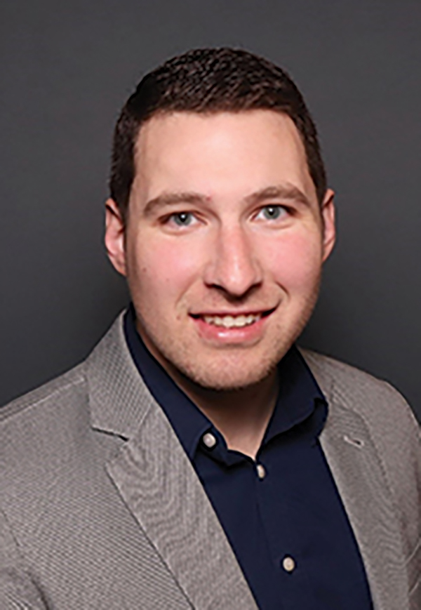 Portrait headshot photo of Chris Hibbs smiling