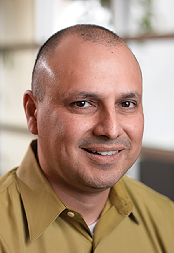 Portrait headshot photo of Eliot Jordan smiling