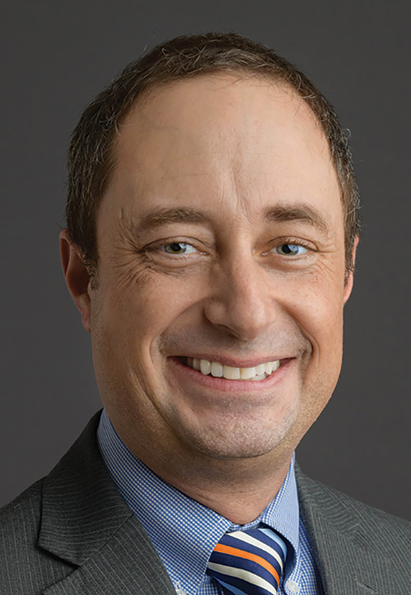 Portrait headshot photo of Ethan Tyler smiling