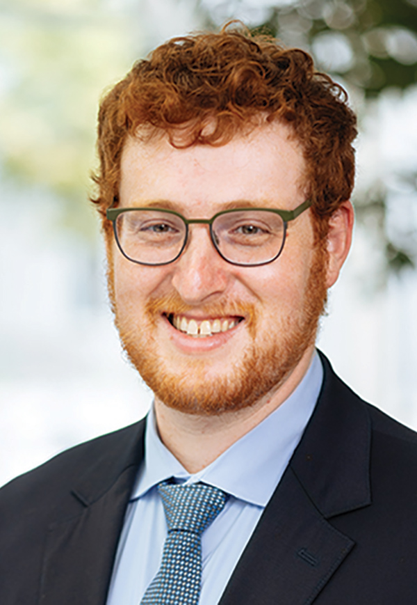 Portrait headshot photo of Noah Star smiling