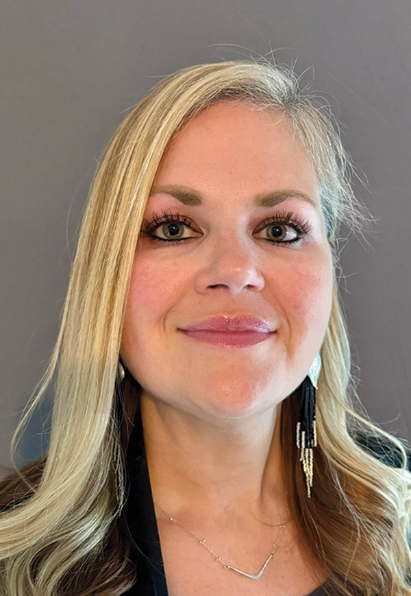 Portrait headshot photo of Theresa Cross grinning