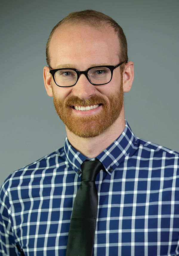 Portrait headshot photograph of AJ Schirack smiling