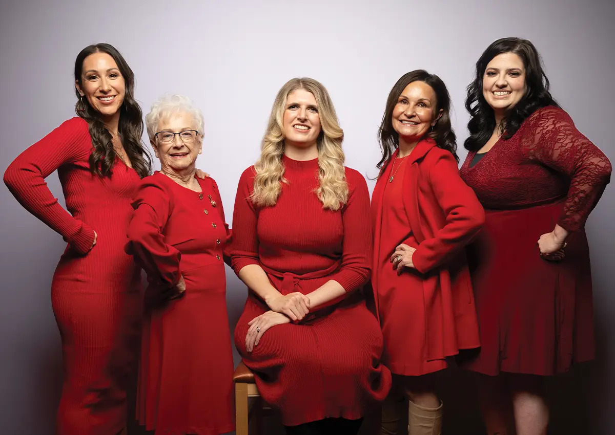 Five smiling women wearing different styled red dresses stand with their hands on their hips; from Left to Right: Sarah Mattie, Survivor, Postpartum Cardiomyopathy; Jimmie Russell, Survivor, Heart Disease; Andrea Witte, Survivor, Marfan Syndrome & Heart Disease; Ella Goss, Board Member, American Heart Association – Western States; Chelsea Hunt, Survivor, Stroke