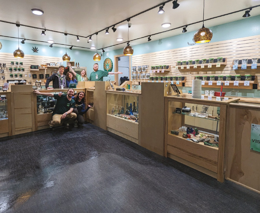 employees at Nature’s Releaf in front of their shelves and counters fully stocked