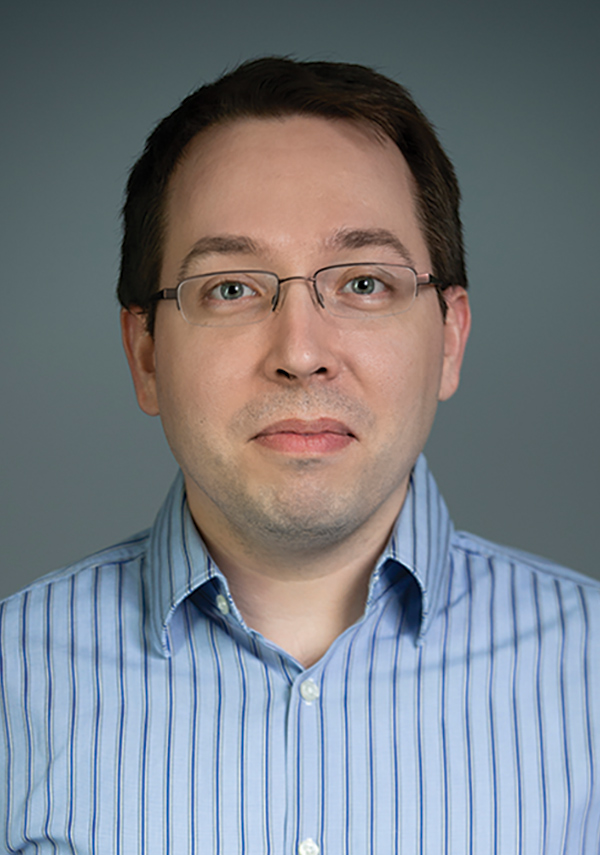Portrait headshot photograph of Frank Silberer grinning