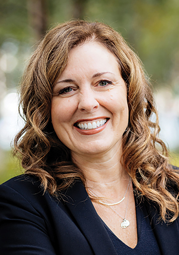 Portrait headshot photograph of Maureen McCabe Moore smiling