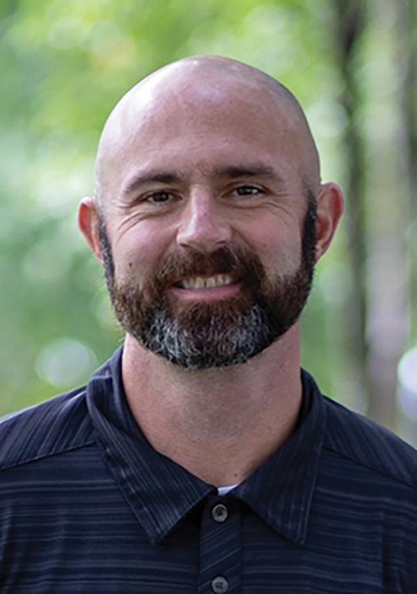 Portrait headshot photograph of Steven Udall smiling