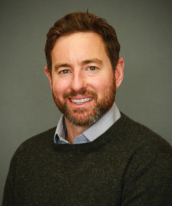 Portrait headshot photograph of Clark Hill smiling