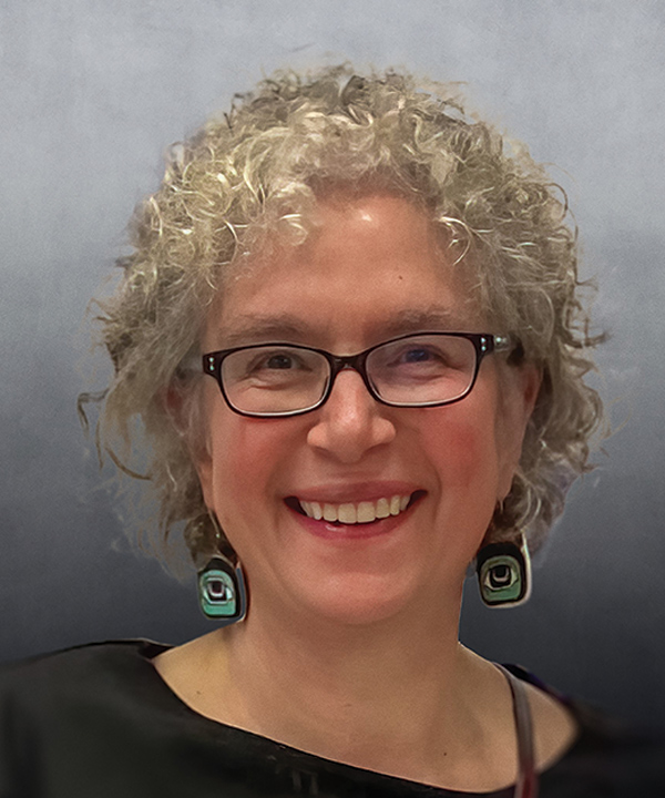 Portrait headshot photograph of Susan Bell smiling