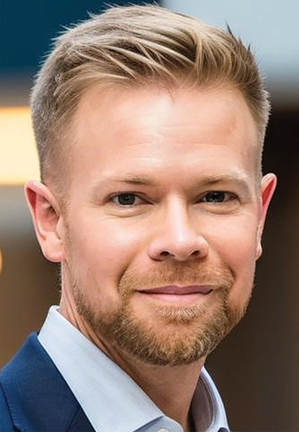 Portrait headshot photograph of Daniel A. Bentle grinning