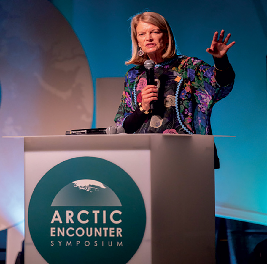 woman speaking at podium during Arctic Encounter conference
