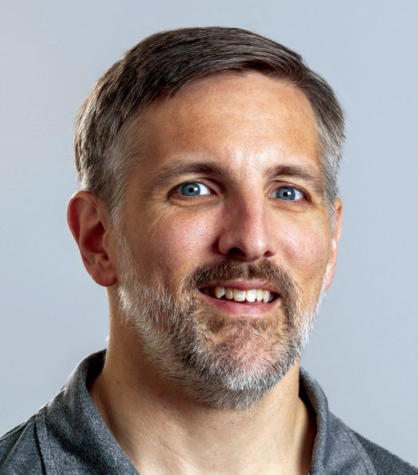 Portrait headshot photograph of Bryan Hudson smiling